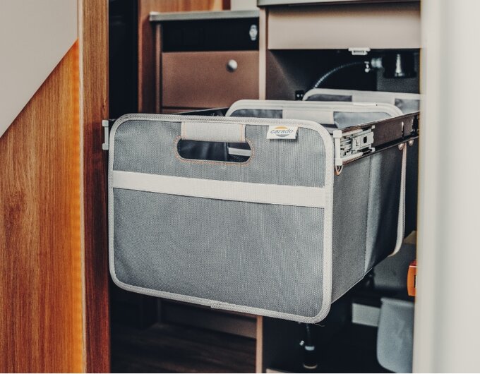 Pull-out fabric basket in a Carado motorhome cupboard