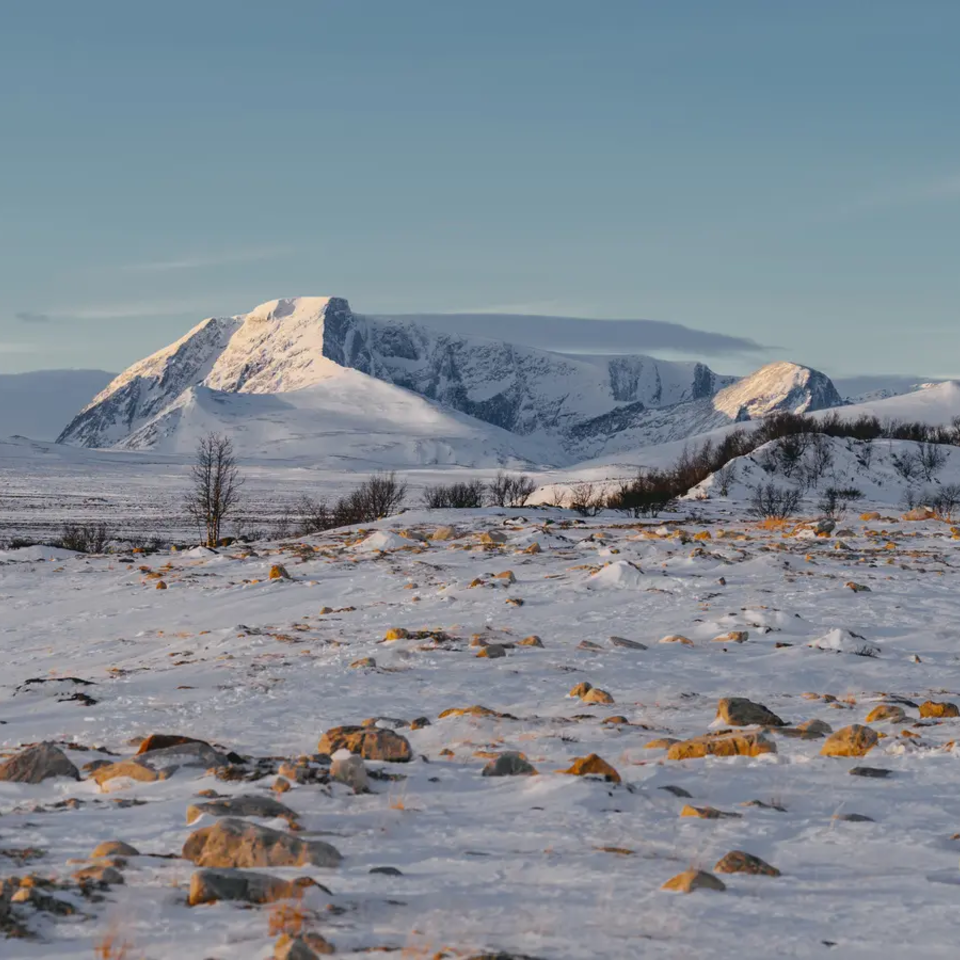 Snowy landscape, high mountains in the background